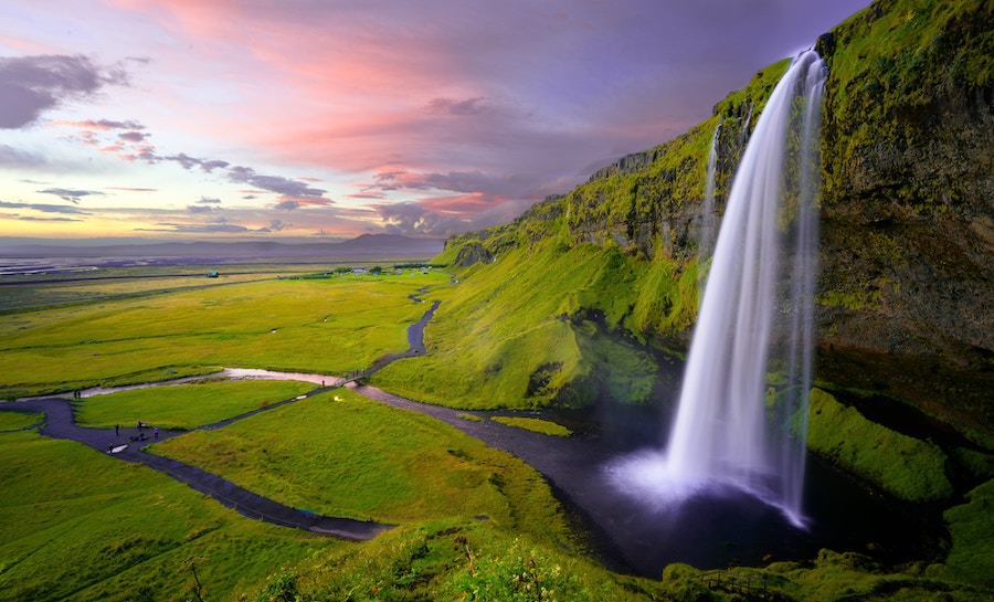 Seljalandsfoss waterfall in Iceland during the summer. All Things Iceland podcast.
