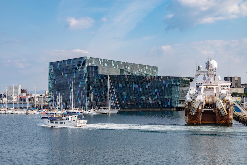 Old Icelandic harbor and Harpa concert hall in the distance